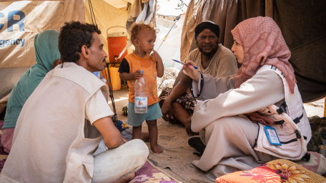 A woman conducts an assessment mission with a family