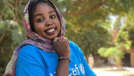 A teenager girl smiling at the camera