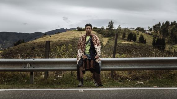 A refugee treks along a major road