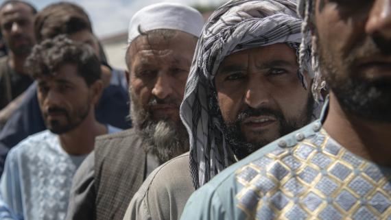 Flood victims line up to receive a pre-package of food