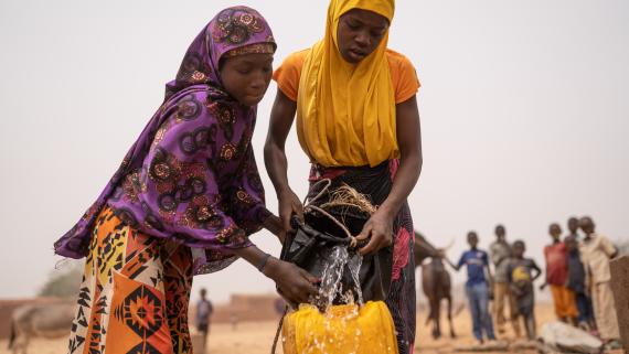 Two girls fetch water